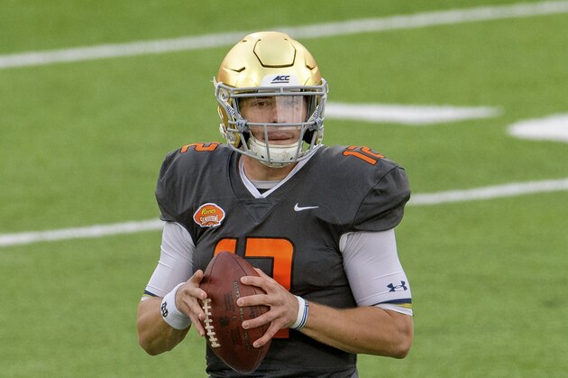National Team quarterback Ian Book of Notre Dame (12) throws during the NCAA Senior Bowl college football game in Mobile, Ala., Saturday, Jan. 30, 2021. (AP Photo/Matthew Hinton)