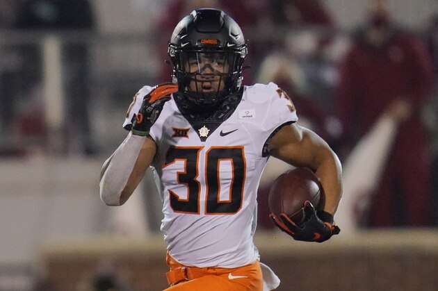 Oklahoma State running back Chuba Hubbard (30) carries during an NCAA college football game against Oklahoma in Norman, Okla., Saturday, Nov. 21, 2020. (AP Photo/Sue Ogrocki)