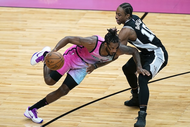 Miami Heat forward Trevor Ariza, left, drives to the basket as San Antonio Spurs forward DeMar DeRozan (10) defends during the first half of an NBA basketball game Wednesday, April 28, 2021, in Miami. (AP Photo/Lynne Sladky)