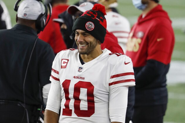 San Francisco 49ers quarterback Jimmy Garoppolo smiles at teammates on the bench during an NFL football game against the New England Patriots at Gillette Stadium, Sunday, Oct. 25, 2020 in Foxborough, Mass. (Winslow Townson/AP Images for Panini)