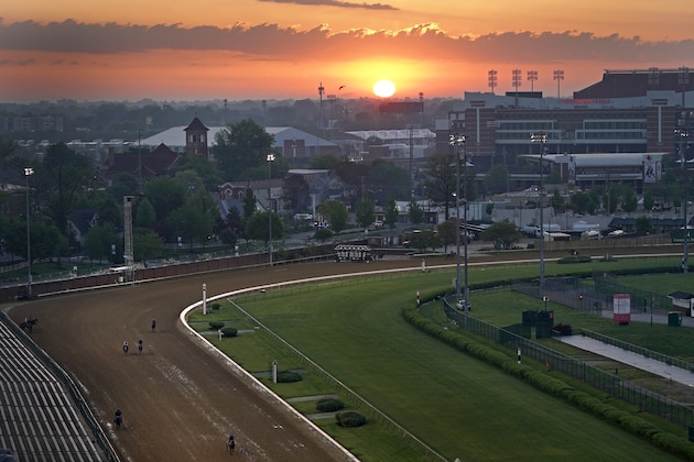 Horses work out as the sun rises at Churchill Downs Friday, April 30, 2021, in Louisville, Ky. The 147th running of the Kentucky Derby is scheduled for Saturday, May 1. (AP Photo/Charlie Riedel)