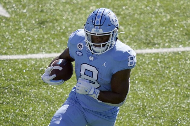 North Carolina running back Michael Carter (8) runs against North Carolina State during the first half of an NCAA college football game in Chapel Hill, N.C., Saturday, Oct. 24, 2020. (AP Photo/Gerry Broome)