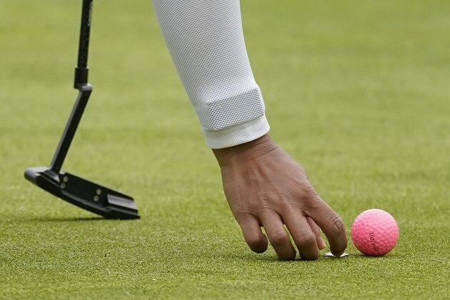 Pornanong Phatlum places a marker on the third green in place of her pink ball during the third round of the LPGA's Hugel-Air Premia LA Open golf tournament at Wilshire Country Club Friday, April 23, 2021, in Los Angeles. (AP Photo/Ashley Landis)