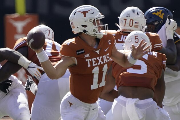 Texas' Sam Ehlinger (11) looks to pass against West Virginia during the first half of an NCAA college football game in Austin, Texas, Saturday, Nov. 7, 2020. (AP Photo/Chuck Burton)
