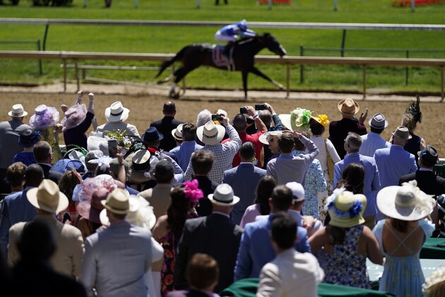 Fans cheers during race five before the 147th running of the Kentucky Derby at Churchill Downs, Saturday, May 1, 2021, in Louisville, Ky. (AP Photo/Charlie Riedel)
