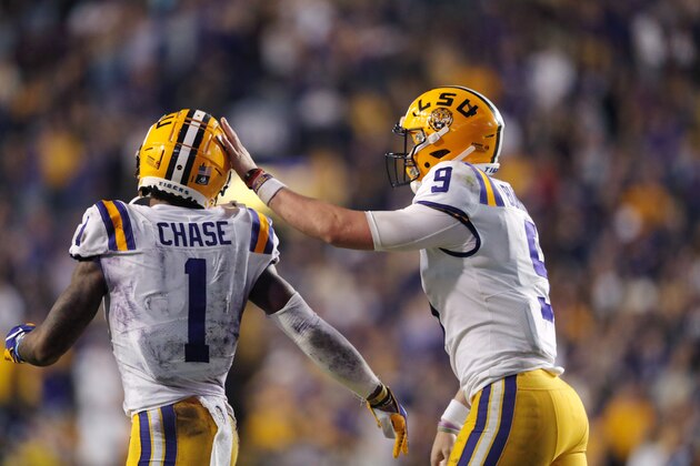 LSU quarterback Joe Burrow (9) celebrates with wide receiver Ja'Marr Chase (1) on their touchdown pass play during the second half of the team's NCAA college football game against Texas A&M in Baton Rouge, La., Saturday, Nov. 30, 2019. LSU won 50-7. (AP Photo/Gerald Herbert)
