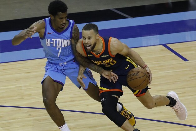 Houston Rockets' Stephen Curry (30) drives on Houston Rockets' Armoni Brooks (7) during the second quarter of an NBA basketball game Saturday, May 1, 2021, in Houston. (Bob Levey/Pool Photo via AP)