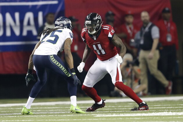 Atlanta Falcons wide receiver Julio Jones (11) works against Seattle Seahawks cornerback Richard Sherman (25) during the second half of an NFL football divisional football game, Saturday, Jan. 14, 2017, in Atlanta. (AP Photo/John Bazemore)