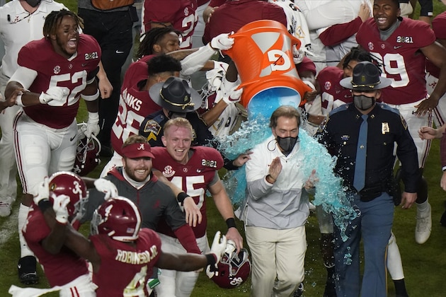 Alabama head coach Nick Saban is soaked in a sports drink after their win against Ohio State in an NCAA College Football Playoff national championship game, Monday, Jan. 11, 2021, in Miami Gardens, Fla. Alabama won 52-24. (AP Photo/Wilfredo Lee)