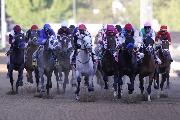John Velazquez on Medina Spirit, third from right, leads the pack into turn one during the 147th running of the Kentucky Derby at Churchill Downs, Saturday, May 1, 2021, in Louisville, Ky. Velazquez rode Medina Spirit to victory. (AP Photo/Michael Conroy)
