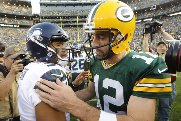 Green Bay Packers' Aaron Rodgers talks to Seattle Seahawks' Russell Wilson after an NFL football game Sunday, Sept. 10, 2017, in Green Bay, Wis. The Packers won 17-9. (AP Photo/Mike Roemer)