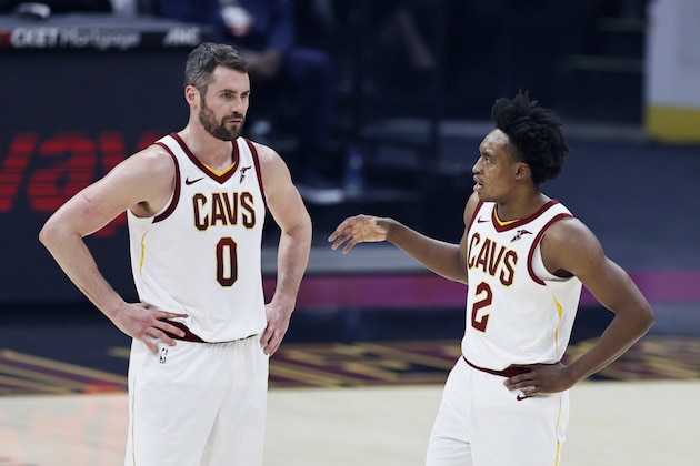 Cleveland Cavaliers' Collin Sexton (2) talks with Kevin Love (0) during the first half of an NBA basketball game against the Washington Wizards, Friday, April 30, 2021, in Cleveland. (AP Photo/Ron Schwane)