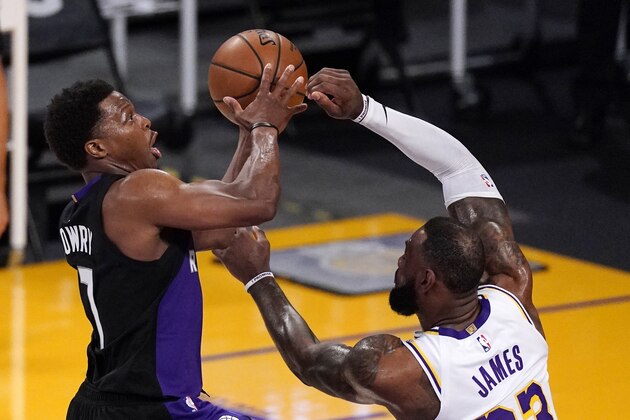 Toronto Raptors guard Kyle Lowry, left, shoots as Los Angeles Lakers forward LeBron James defends during the first half of an NBA basketball game Sunday, May 2, 2021, in Los Angeles. (AP Photo/Mark J. Terrill)