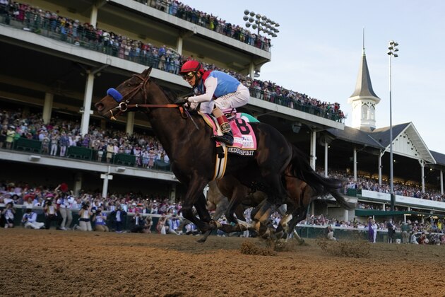 John Velazquez rides Medina Spirit across the finish line to win the 147th running of the Kentucky Derby at Churchill Downs, Saturday, May 1, 2021, in Louisville, Ky. (AP Photo/Jeff Roberson)