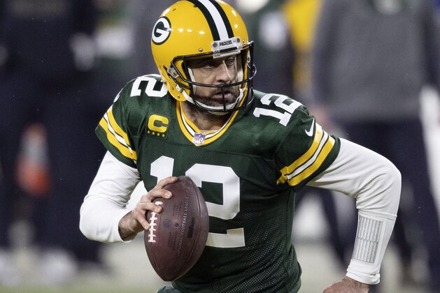 FILE - In this Jan. 16, 2021, file photo, Green Bay Packers quarterback Aaron Rodgers (12) runs during an NFL divisional playoff football game against the Los Angeles Rams in Green Bay, Wis. Packers general manager Brian Gutekunst says the team remains committed to Rodgers “for the foreseeable future” one year after trading up in the first round to draft the three-time MVP’s potential successor. (AP Photo/Jeffrey Phelps, File)