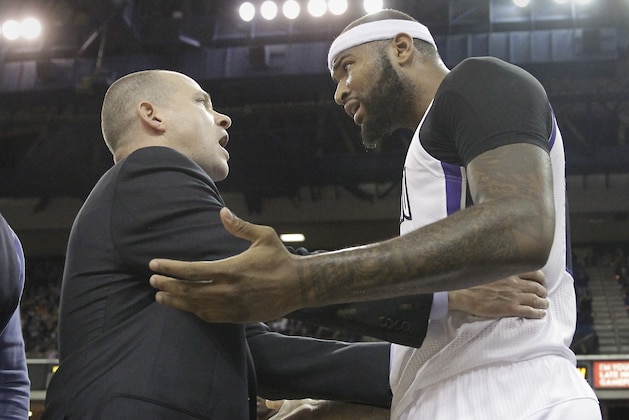 Sacramento Kings head coach Michael Malone, left, calms Kings center DeMarcus Cousins after he was called with a flagrant 2 foul during the fourth quarter of an NBA basketball game against the Golden State Warriors in Sacramento, Calif., Sunday, Dec. 1, 2013.   After a revue, the officials changed the call to an offensive foul. The Warriors won 115-113.(AP Photo/Rich Pedroncelli)