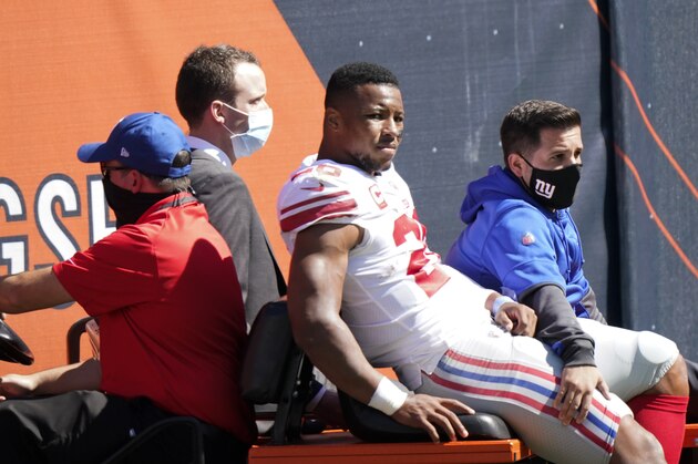 New York Giants running back Saquon Barkley (26) is carted to the locker room after being injured during the first half of an NFL football game against the Chicago Bears in Chicago, Sunday, Sept. 20, 2020. (AP Photo/Nam Y. Huh)