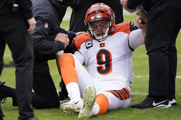 Cincinnati Bengals quarterback Joe Burrow (9) is helped getting off the field during the second half of an NFL football game against the Washington Football Team, Sunday, Nov. 22, 2020, in Landover, Md. Bengals rookie suffered a left knee injury during this play and was carted off the field. (AP Photo/Susan Walsh)