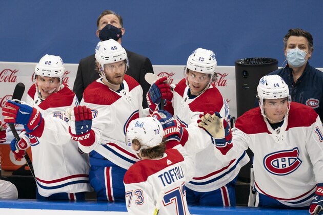 Montreal Canadians center Tyler Toffoli(73) celebrates with teammates after scoring the tying goal during an NHL hockey game against the Toronto Maple Leafs, Saturday, Feb. 13, 2021, in Toronto, Canada. (AP Photo/Peter Power)
