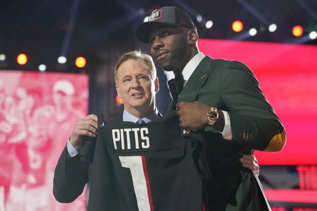 Florida tight end Kyle Pitts, right, holds a jersey with NFL Commissioner Roger Goodell after he was chosen by the Atlanta Falcons with the fourth pick in the NFL football draft, Thursday, April 29, 2021, in Cleveland. (AP Photo/Tony Dejak)