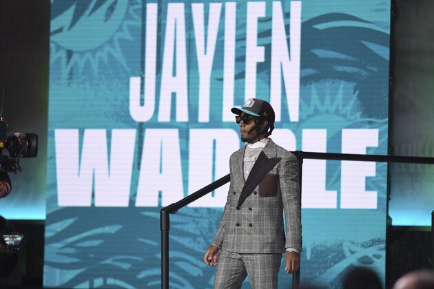 Alabama wide receiver Jaylen Waddle walks down the runway after being chosen by the Miami Dolphins with the sixth pick in the NFL football draft Thursday April 29, 2021, in Cleveland. (AP Photo/David Dermer)
