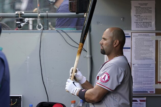 Los Angeles Angels' Albert Pujols stands in the dugout during a baseball game against the Seattle Mariners, Sunday, May 2, 2021, in Seattle. (AP Photo/Ted S. Warren)