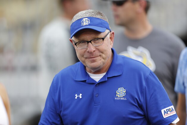 South Dakota State head coach John Stiegelmeier smiles as he enters the field for an NCAA college football game against Iowa State, Saturday, Sept. 1, 2018, in Ames, Iowa. (AP Photo/Matthew Putney)