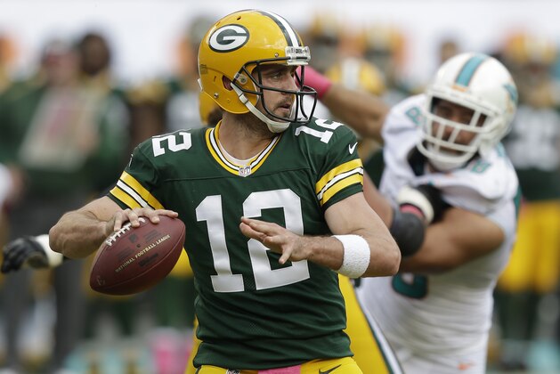 Green Bay Packers quarterback Aaron Rodgers (12) looks to pass during the first half of an NFL football game against the Miami Dolphins, Sunday, Oct. 12, 2014, in Miami Gardens, Fla. (AP Photo/Wilfredo Lee)