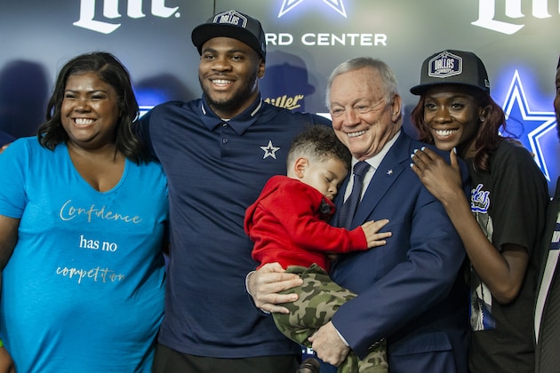 Dallas Cowboys first round draft pick linebacker Micah Parsons, second from left, poses for photos with his mom, Sherese Parsons, left, son Malcom, 2, owner Jerry Jones, fourth from left, sister Shatara Parsons, fifth from left, and father Terrence Parsons Sr., right, at the Dallas Cowboys headquarters, Friday, April 30, 2021, in Frisco, Texas. (AP Photo/Brandon Wade)