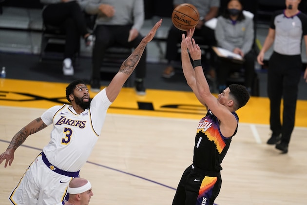 Phoenix Suns guard Devin Booker, right, shoots over Los Angeles Lakers forward Anthony Davis (3) during the first half of an NBA basketball game Sunday, May 9, 2021, in Los Angeles. (AP Photo/Marcio Jose Sanchez) Phoenix Suns guard Devin Booker, right, shoots over Los Angeles Lakers forward Anthony Davis (3) during the first half of an NBA basketball game Sunday, May 9, 2021, in Los Angeles. (AP Photo/Marcio Jose Sanchez)