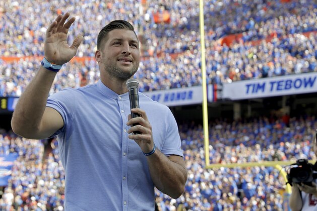 Former Florida football player Tim Tebow speaks to fans after he was inducted in the Ring of Honor at Florida Field during the first half of an NCAA college football game against LSU, Saturday, Oct. 6, 2018, in Gainesville, Fla. (AP Photo/John Raoux)