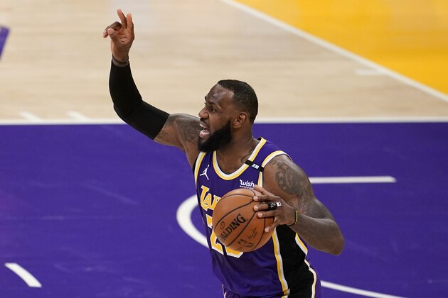 Los Angeles Lakers forward LeBron James directs the offense against the Sacramento Kings during the first half of an NBA basketball game Friday, April 30, 2021, in Los Angeles. (AP Photo/Marcio Jose Sanchez)