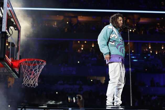 Rapper J. Cole performs at halftime during NBA All-Star basketball game, Sunday, Feb. 17, 2019, in Charlotte, N.C. (AP Photo/Chuck Burton)