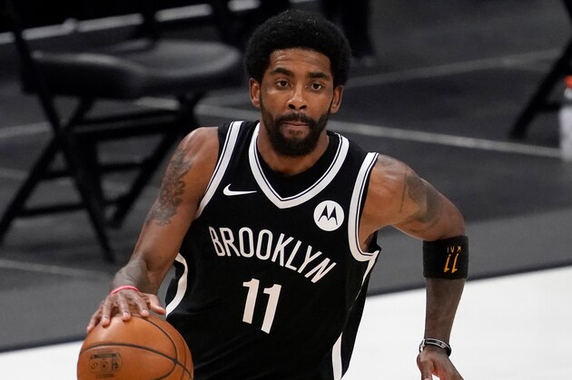 Brooklyn Nets' Kyrie Irving (11) handles the ball during an NBA basketball game against the Dallas Mavericks in Dallas, Thursday, May 6, 2021. (AP Photo/Tony Gutierrez)