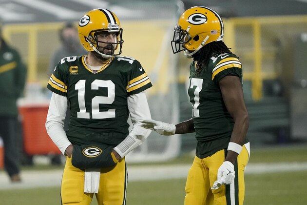Green Bay Packers' Aaron Rodgers talks to Davante Adams during the first half of an NFL football game against the Carolina Panthers Saturday, Dec. 19, 2020, in Green Bay, Wis. (AP Photo/Morry Gash)
