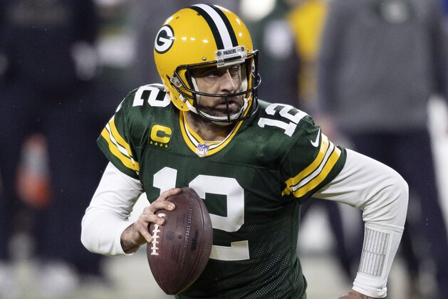 ARCHIVO - En esta foto de archivo del 16 de enero de 2021, Aaron Rodgers, quarterback de los Packers de Green Bay, acarrea el balón durante un partido de playoffs ante los Rams de Los Ángeles (AP Foto/Jeffrey Phelps, archivo)