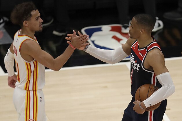 Washington Wizards' Russell Westbrook, right, is congratulated by Atlanta Hawks' Trae Young after an NBA basketball game Monday, May 10, 2021, in Atlanta. Westbrook recorded his 182nd career triple-double, passing Oscar Robertson for the most in NBA history. (AP Photo/Ben Margot)