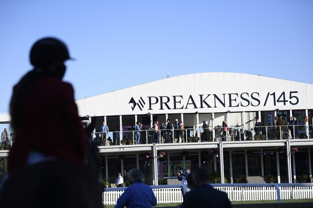 A rider is seen in silhouette ahead of the 145th Preakness horse race, Saturday, Oct. 3, 2020, in Baltimore. (AP Photo/Nick Wass)