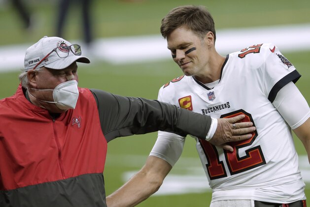 FILE - In this Jan. 17, 2021, file photo, Tampa Bay Buccaneers coach Bruce Arians, left, speaks with quarterback Tom Brady before the team's NFL divisional round playoff football game against the New Orleans Saints in New Orleans. Both Andy Reid and Arians are considered players’ coaches, though they do it in different ways. It's a quality that’s helped them reach the Super Bowl. (AP Photo/Brett Duke, File)