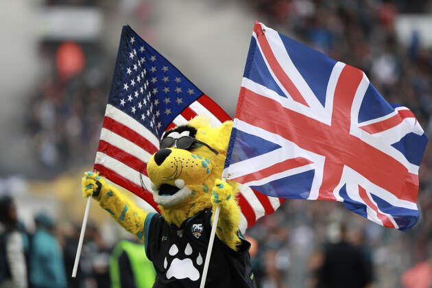 The Jacksonville Jaguars mascot carries the flags of the United States and Great Britian ahead of an NFL football game between the Houston Texans and the Jacksonville Jaguars, at Wembley Stadium, Sunday, Nov. 3, 2019, in London. (AP Photo/Ian Walton)