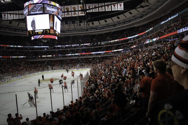 A crowd of about 15,000 people watch the Stanley Cup champion Chicago Blackhawks at their first NHL practice practice and scrimmage of the season at the United Center on Saturday Sept. 18, 2010 in Chicago. (AP Photo/Charles Cherney)