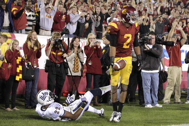 Southern California wide receiver Robert Woods(2) celebrates after scoring a touchdown against UCLA cornerback Sheldon Price(22) during the second half of an NCAA college football game in Los Angeles, Saturday, Nov. 26, 2011. (AP Photo/Jae Hong)