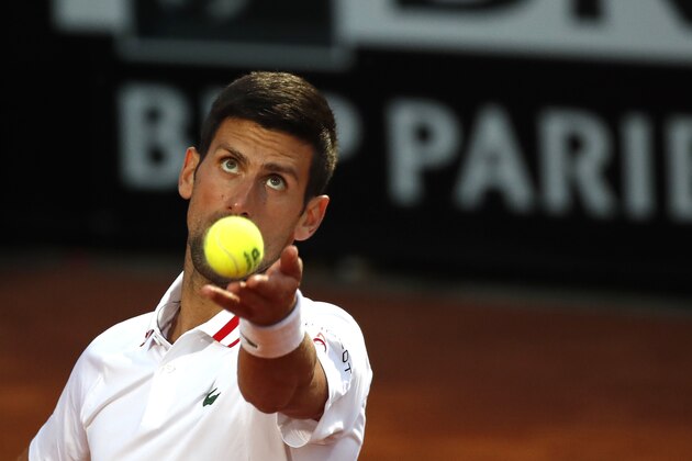 Novak Djokovic of Serbia serves the ball to Taylor Fritz of the United States during their match at the Italian Open tennis tournament, in Rome, Tuesday, May 11, 2021. (AP Photo/Alessandra Tarantino)