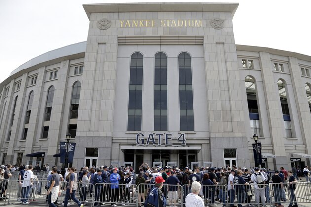 Baseball fans line up outside Yankee Stadium before a game against the Tampa Bay Rays, Monday, April 10, 2017, in New York. (AP Photo/Seth Wenig)