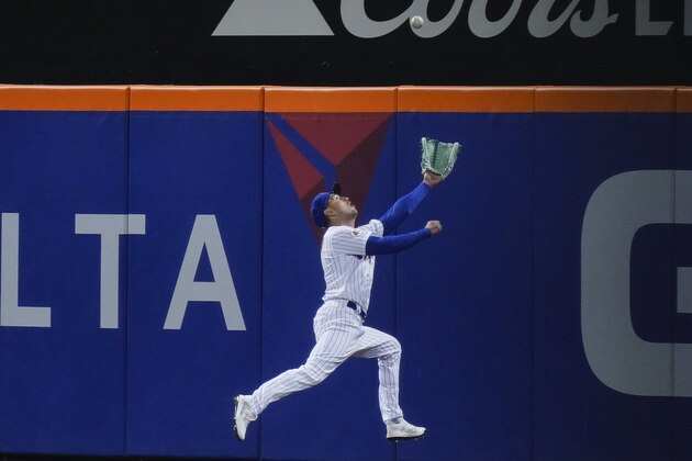 New York Mets' Albert Almora Jr. (4) chases a ball hit by Baltimore Orioles' Austin Hays for a triple during the eighth inning of a baseball game Tuesday, May 11, 2021, in New York. Almora Jr. was injured when he collided with the wall. (AP Photo/Frank Franklin II)