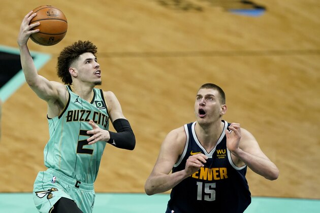 Charlotte Hornets guard LaMelo Ball shoots over Denver Nuggets center Nikola Jokic during the second half of an NBA basketball game on Tuesday, May 11, 2021, in Charlotte, N.C. (AP Photo/Chris Carlson)