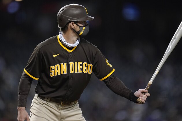 While wearing a face covering, San Diego Padres' Wil Myers steps in the bat against the Arizona Diamondbacks during the eighth inning of a baseball game Wednesday, April 28, 2021, in Phoenix. (AP Photo/Ross D. Franklin)