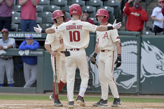 Arkansas batter Matt Goodheart (10) is greeted by teammates Braydon Webb (8) and Cayden Wallace (7) after hitting a home run against Memphis during an NCAA baseball game on Wednesday, March 24, 2021, in Fayetteville, Ark. (AP Photo/Michael Woods)