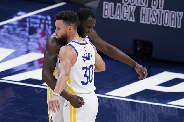 Golden State Warriors' Draymond Green and Stephen Curry embrace following the team's NBA basketball game against the Indiana Pacers, Wednesday, Feb. 24, 2021, in Indianapolis. (AP Photo/Darron Cummings)