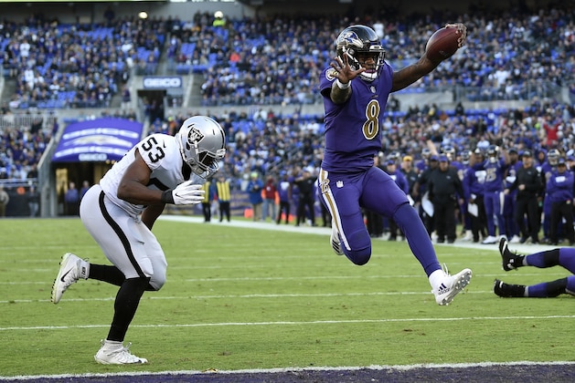 FILE - In this Nov. 25, 2018, file photo, Baltimore Ravens quarterback Lamar Jackson (8) scores a touchdown in front of Oakland Raiders linebacker Jason Cabinda during the second half of an NFL football game in Baltimore. With Jackson poised for his possible first road start, the Ravens will look for their third straight win when they face the Atlanta Falcons, who have lost three straight, on Sunday. (AP Photo/Nick Wass, File)